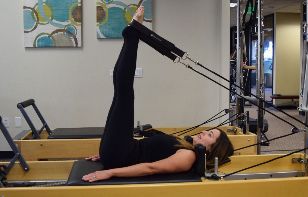 Feet in Straps with the Magic Circle on the Pilates Reformer 